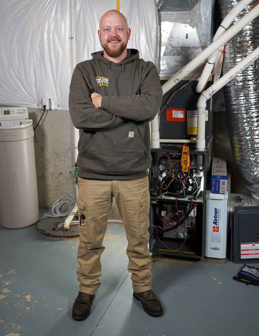 Technician next to a furnace